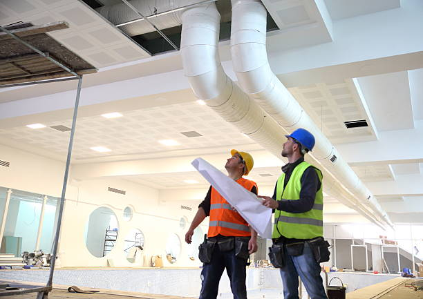 Ventilation engineers inspecting ductwork